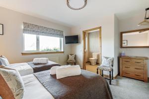 Tempat tidur dalam kamar di Skye Lodge Dunvegan Skye