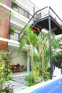a building with a staircase next to a pool at Chaba Place in Hua Hin