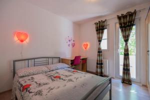 a bedroom with a bed and a desk and a window at Villa Marchelina in Grubine +46 photos