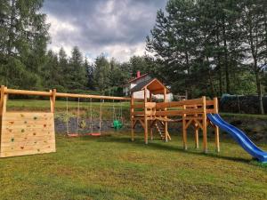 a playground with a slide and a swing set at SielskoAnielsko w Beskidzie Niskim in Męcina Wielka