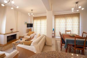 a living room with a couch and a table at MisterCrete Holidays House in Milatos