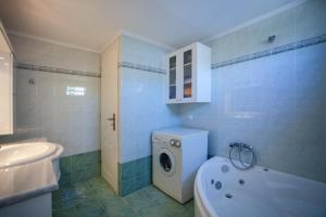 a bathroom with a washing machine and a sink at MisterCrete Holidays House in Milatos +16 photos