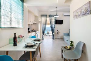 a kitchen and living room with a table and chairs at Melina Apartments in Chania Town