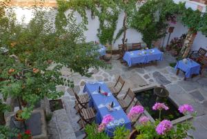a patio area with tables, chairs, and plants at Hotel Labranza in San Martín de Valdeiglesias