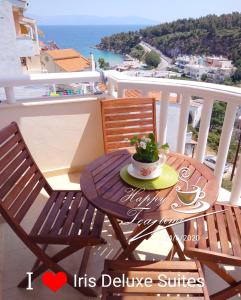 a table with a cup of coffee on a balcony at Iris Deluxe Suites 1 in Kavála