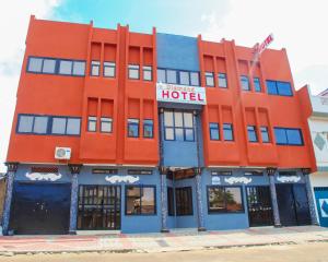 an orange hotel on the corner of a street at Diamond hotel in Cotonou