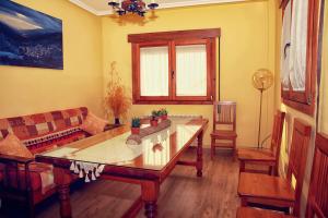 a living room with a couch and a table at Apartamento Turistico Rio Jerte in Navaconcejo