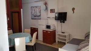 a small room with a small table and a microwave at Apartment Katica in Crikvenica
