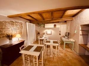 a room with tables and stools in a room at L’Oca Giuliva Relais in Gaggio Montano
