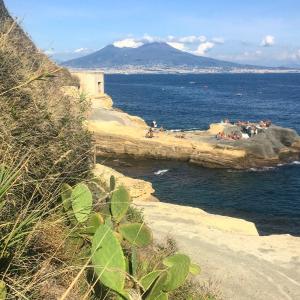 a group of people on a beach near the ocean at 6 Small rooms in Naples +18 photos