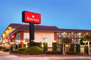 a red sign in front of a hotel at Ramada by Wyndham Pasadena in Pasadena