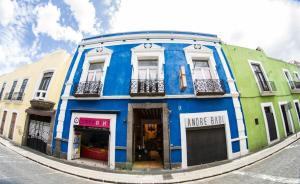 a blue building on the side of a street at La Fuente Catedral in Puebla