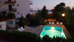 a swimming pool in front of a building at Apartment Katica in Crikvenica
