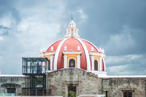 a building with a red dome on top of it at La Fuente Catedral in Puebla