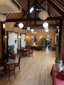 a large room with tables and chairs in a building at The Carre Arms Hotel & Restaurant in Sleaford