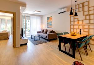 a living room with a table and a couch at Luxury apartment Concept in Mostar