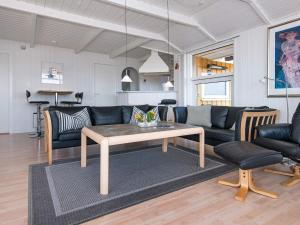 een woonkamer met een bank en een tafel bij 8 person holiday home in Sj lund in Hejls