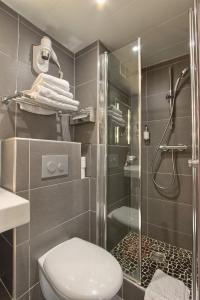 a bathroom with a shower and a toilet and a sink at Villa Margaux Opéra Montmartre in Paris +21 photos
