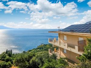 a building with solar panels on top of the ocean at Seaview Studio 5 pers panoramic seaview in beautiful setting in Ravdhoúkha