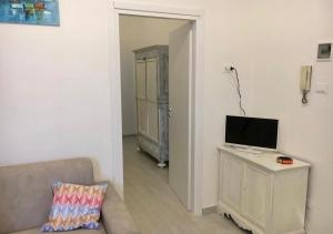 a living room with a couch and a television on a table at Via Aurispa 60 in Palermo