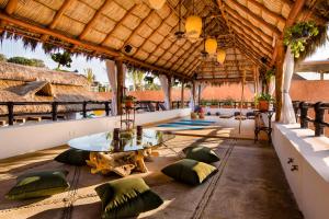 a patio area with chairs, tables, and umbrellas at Selina Sayulita in Sayulita