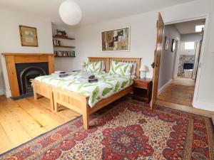 a bedroom with a large bed and a fireplace at 2 Ashby Place in Chester +42 photos