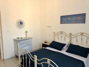 a bedroom with a bed and a dresser at Via Aurispa 60 in Palermo