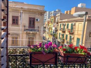 a balcony with two flower boxes on a balcony at Via Aurispa 60 in Palermo