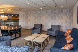 a waiting room with couches and chairs and a table at Bridgewater Hotel, Trademark Collection by Wyndham in Fairbanks