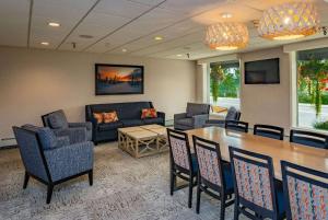 a waiting room with a table and chairs and a couch at Bridgewater Hotel, Trademark Collection by Wyndham in Fairbanks