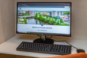 a computer monitor sitting on a desk with a keyboard at Bridgewater Hotel, Trademark Collection by Wyndham in Fairbanks
