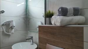 a bathroom with a sink and a toilet and a mirror at Vasiliki House in Sarti