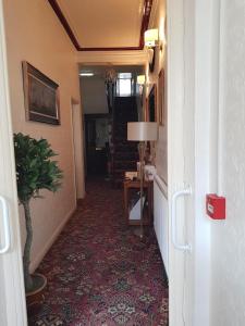 a hallway with a room with a table and a plant at Thornhill Blackpool in Blackpool