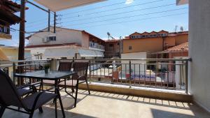 a balcony with a table and chairs on a balcony at Vasiliki House in Sarti