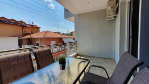 a balcony with a table and chairs on a balcony at Vasiliki House in Sarti
