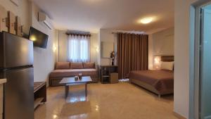 a hotel room with a bed and a couch at Vasiliki House in Sarti