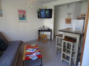 a living room with a couch and a table at Le Perret in Le Havre