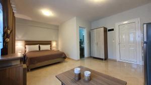 a bedroom with a bed and a table in a room at Vasiliki House in Sarti