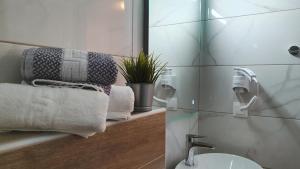 a bathroom with a sink and a mirror and towels at Vasiliki House in Sarti