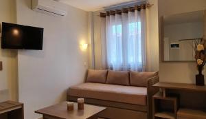 a living room with a couch and a window at Vasiliki House in Sarti