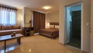 a hotel room with a bed and a couch at Vasiliki House in Sarti