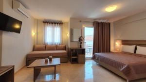a hotel room with a bed and a couch at Vasiliki House in Sarti