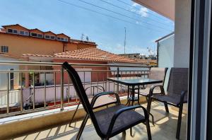 a balcony with a table and chairs on a balcony at Vasiliki House in Sarti