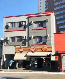 a tall apartment building with awnings on it at Hotel Sany SP- Metrô Paulista in São Paulo +42 photos