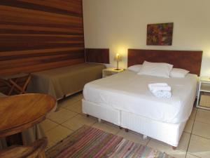 a bedroom with a bed with two towels on it at Pousada La Vivienda in Santana do Livramento