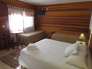Een bed of bedden in een kamer bij Pousada La Vivienda