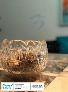a clear glass bowl sitting on top of a table at Maligueira Apartment in Leiria