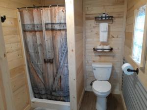 a bathroom with a toilet and a shower at Glacier Acres Guest Ranch in Columbia Falls