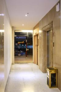 a hallway of a building with a harawi sign on the wall at Aviari Hotel in Sekupang