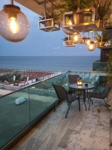 a dining room with a view of the ocean at MaraVali Seaview Mamaia in Mamaia